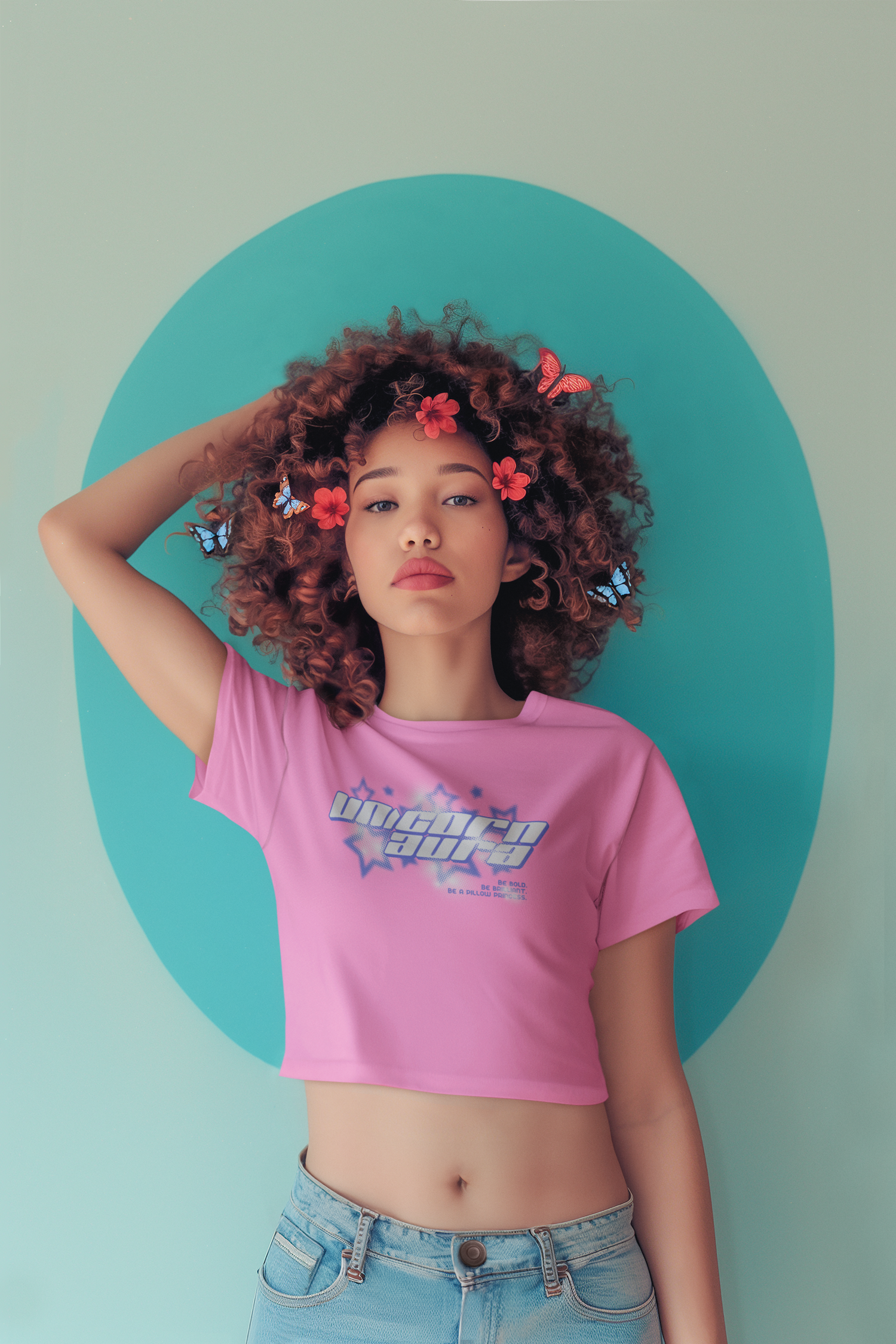 Woman wearing a pink crop top with a graphic design, standing against a light green background.